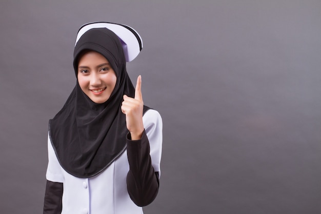 Muslim nurse pointing up finger