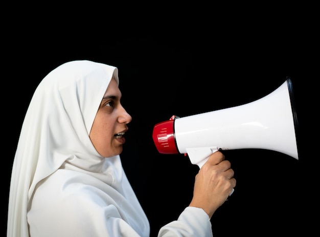 Muslim pilgrim in white traditional clothes saying message on megaphone high quality photo