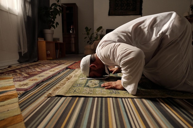 Muslim prayer doing sajdah on rug