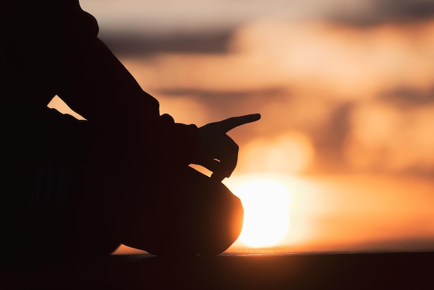 A Muslim prayer praying at sunset