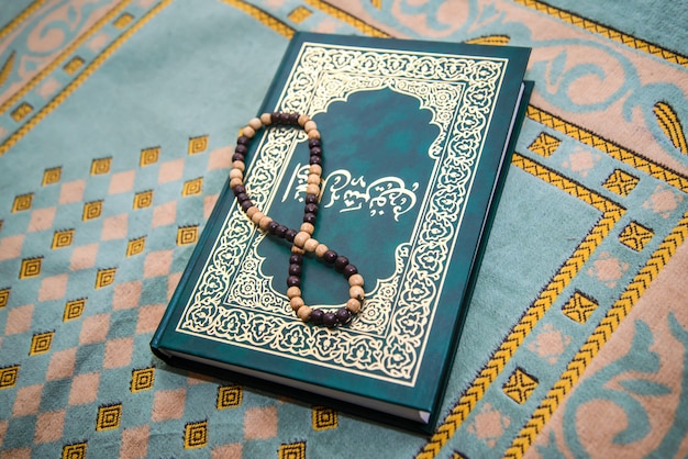 Muslim rosary and prayer book on the rug