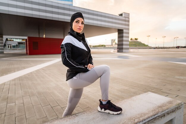 Muslim sportive girl with fit body training outside