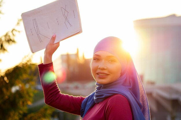 Muslim successful business woman welldressed in park street autumn forest trees