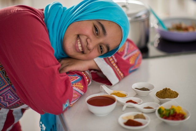 Muslim traditional woman working in kitchen