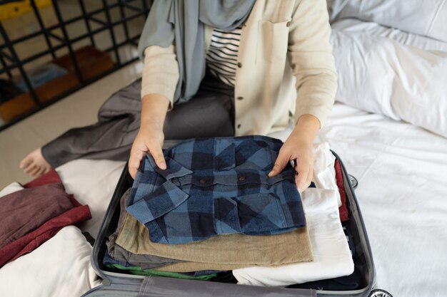 muslim veiled woman packing some clothes