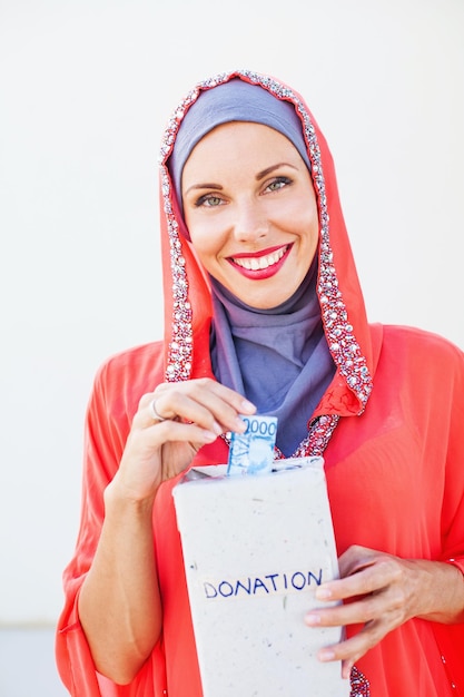 Muslim woman doing donations