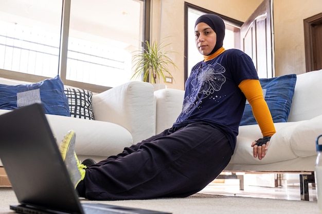 Muslim woman doing exercises in home