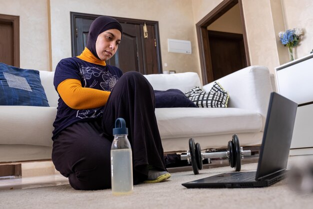 muslim woman doing exercises in home