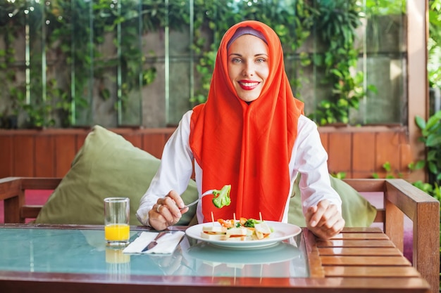 Muslim woman having breakfast