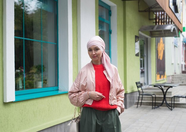 Muslim woman in hijab is looking at camera outside