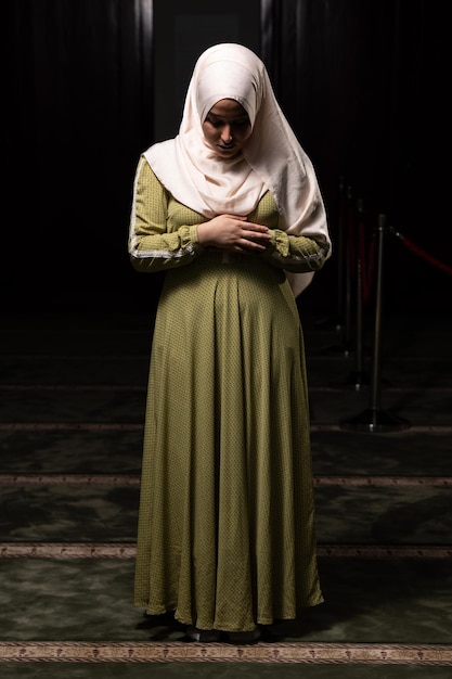 Muslim Woman in Hijab Praying on Mat