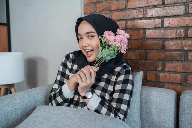 Muslim woman holding flowers