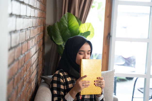 Muslim woman kissing Quran