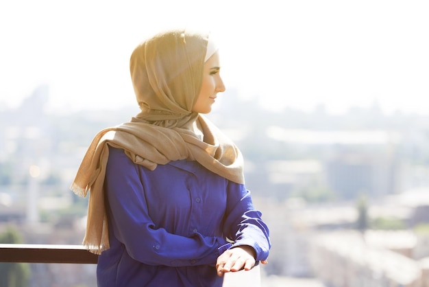 A Muslim woman looks at the sunset