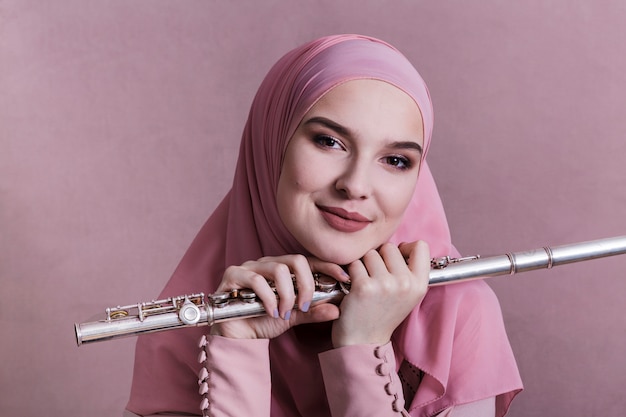 Muslim woman playing on the flute