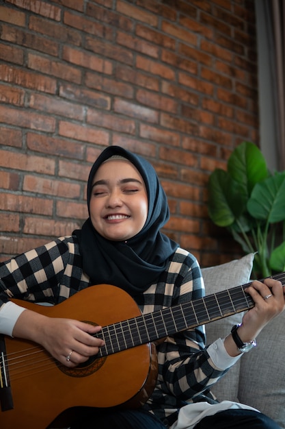 Muslim woman playing guitar