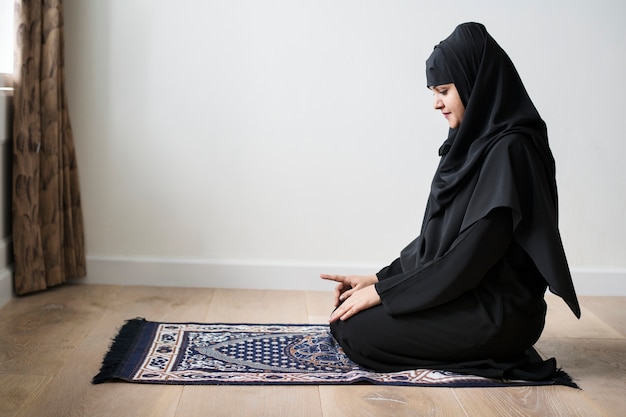 Muslim woman praying in Tashahhud posture