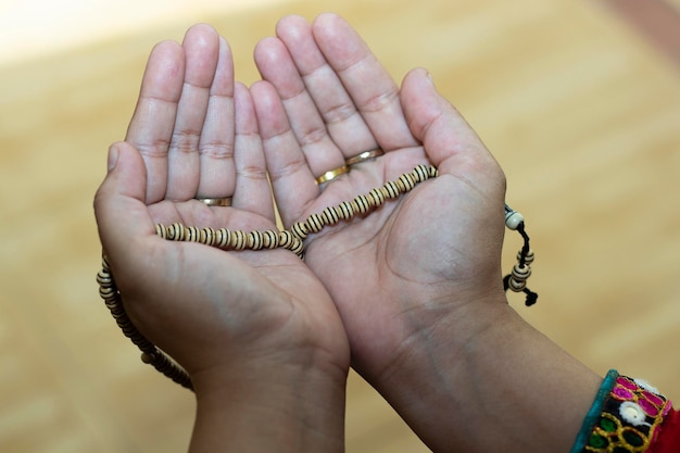 Muslim woman praying Woman praying hands to Allah with Girl of Muslim lady with blurry Background