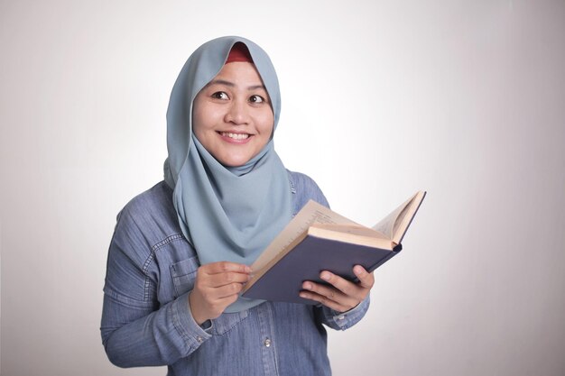 Muslim Woman Reading Book and Thinking