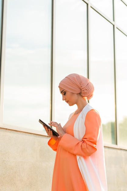 Muslim woman standing  holding document paper