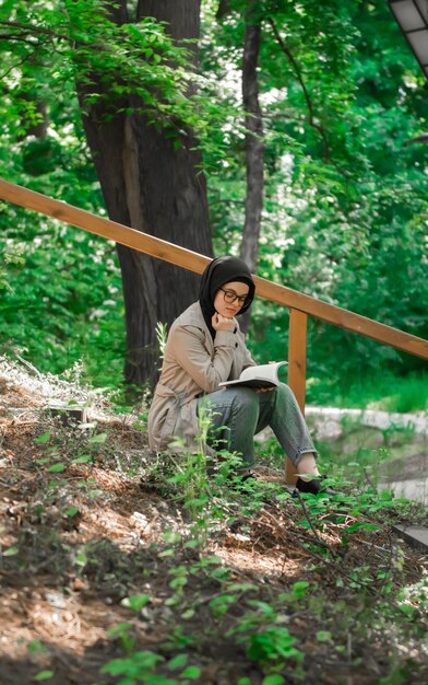 Muslim woman studying her lecture in the park