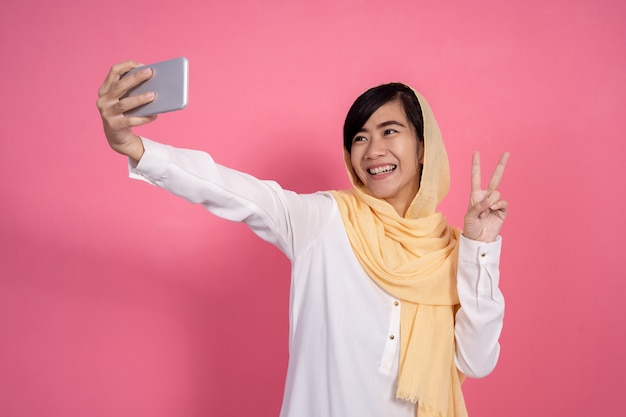 Muslim woman taking selfie