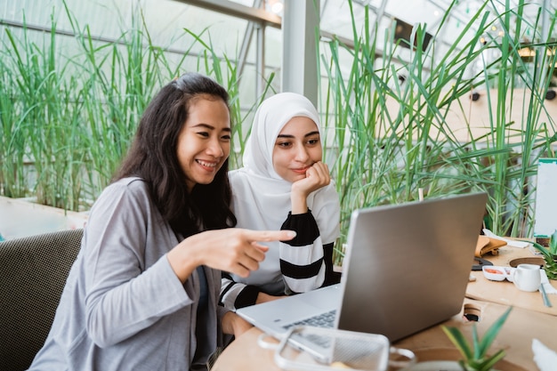 Muslim woman talking in cafe together