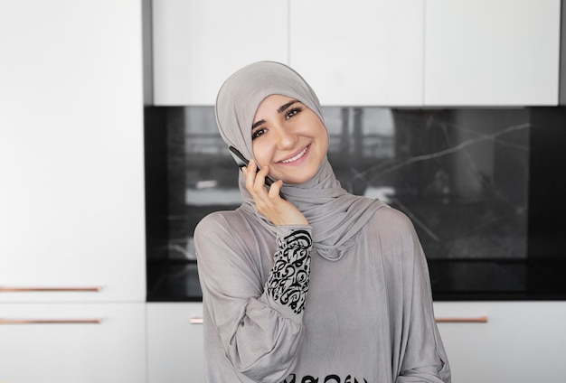 Muslim Woman Using Mobile Phone at home