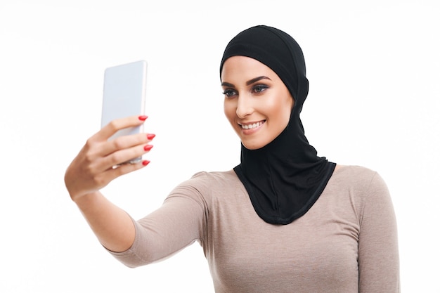 muslim woman using smartphone over white