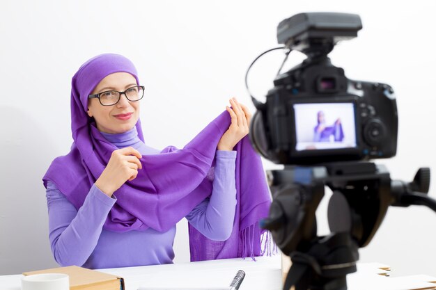 Muslim woman video blog recording. The girl in the hijab leads its vlog for social networks. 