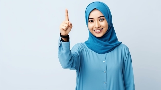 muslim woman with hijab pointing on white background