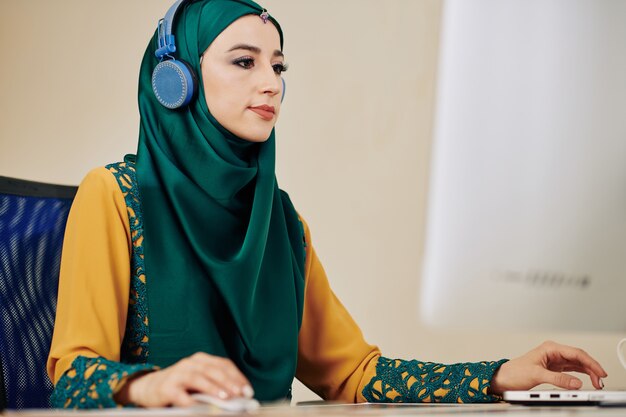 Muslim woman working on computer