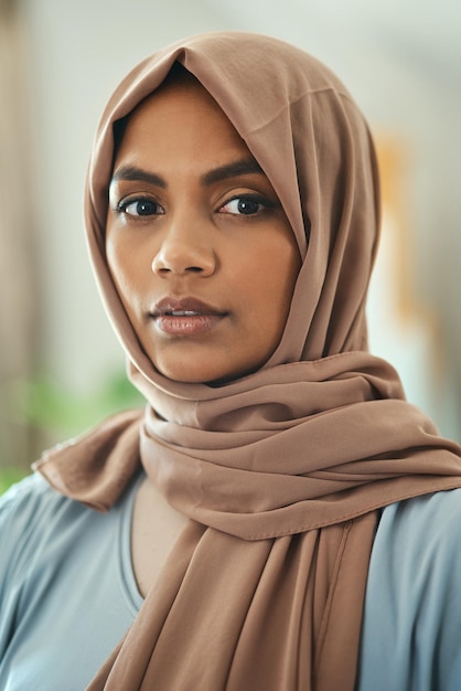 The Muslim Women is Clothed in strength Dignity Shot of a young muslim woman sitting in the loung at home