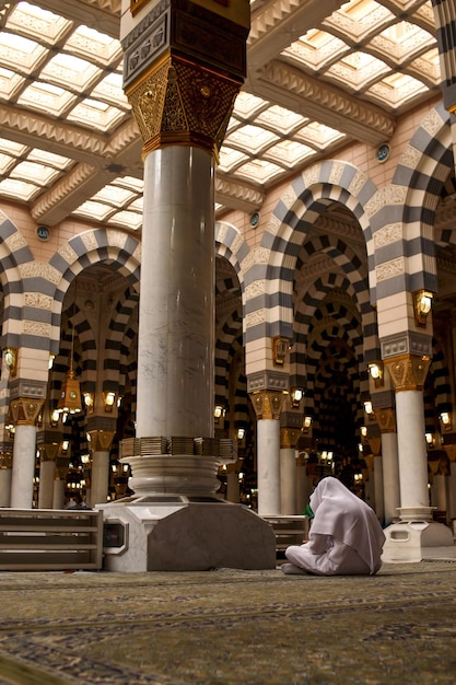 Muslims praying inside Nabawi Mosque. Interior view of Masjidil Nabawi (Nabawi Mosque) in Medina.