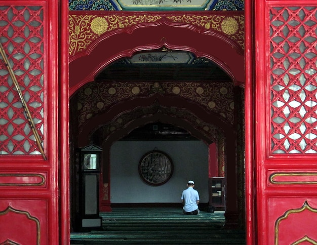 Muslims praying in temple back view