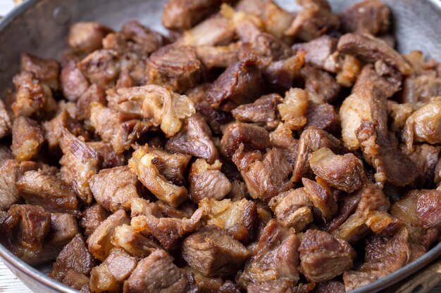 Muslims Traditional Sacrifice holiday food lamb, Turkish roasted meat in copper pot on table top. Turkish Kavurma. (Turkish name; Kurban kavurma)