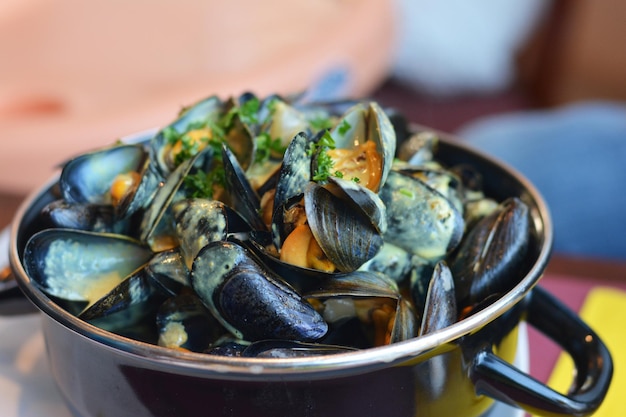 Mussel in a casserole with sauce curry