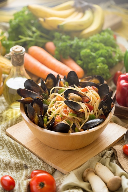 mussel and spaghetti on a deep wooden bowl. homemade food style