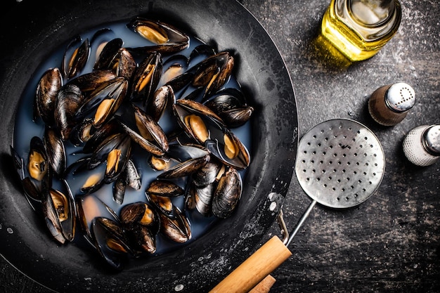 Mussels are cooked in a pot of water