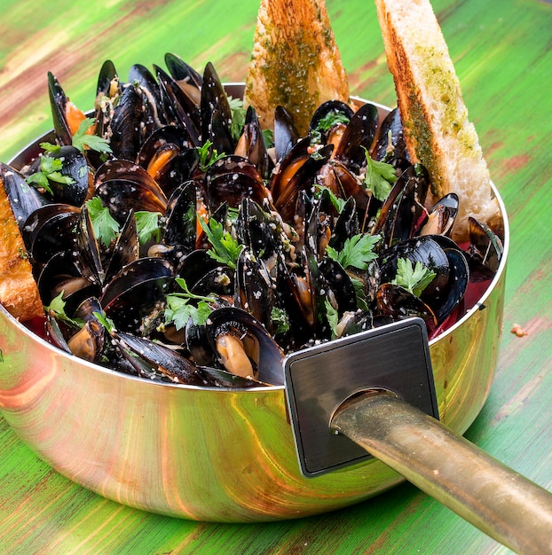 Mussels cooked with white wine In copper utensils