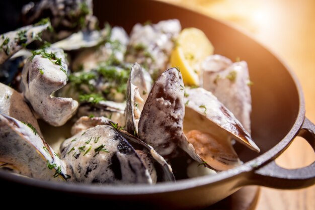 Mussels with garlic white sauce in a bowl. Restaurant