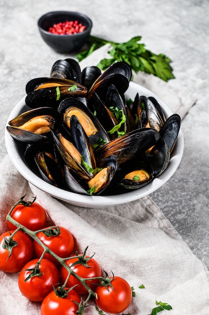 Mussels with herbs and sauce in bowl 