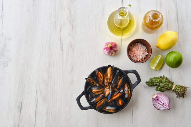 Mussels with spices and herbs on wooden table