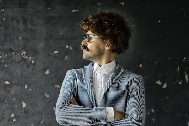 mustachioed man in a classic suit and vintage glasses, curly hipster portrait, long hair