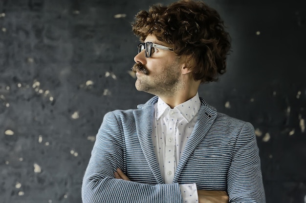 mustachioed man in a classic suit and vintage glasses, curly hipster portrait, long hair