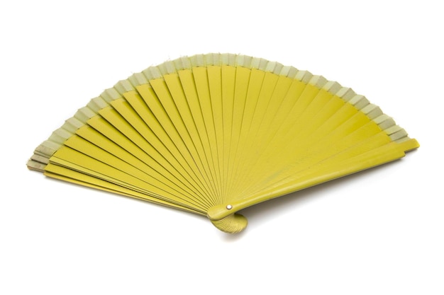 Mustard colored fan, isolated on white background. A fan is a fashion accessory.