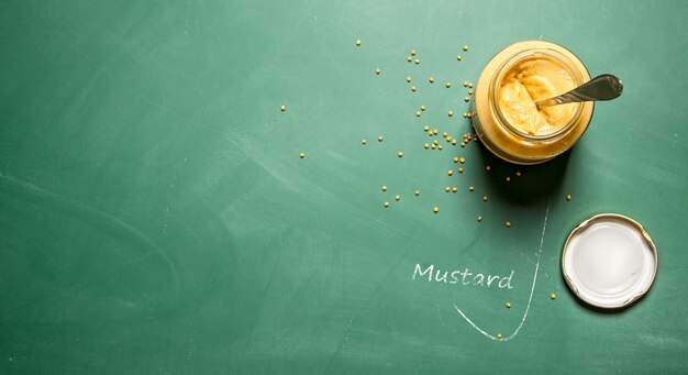 Mustard in the jar  on chalkboard.