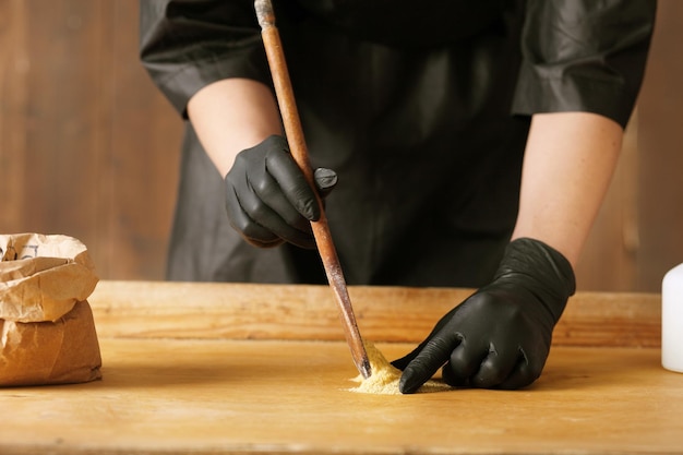 Mustard powder in a wooden spoon and bag