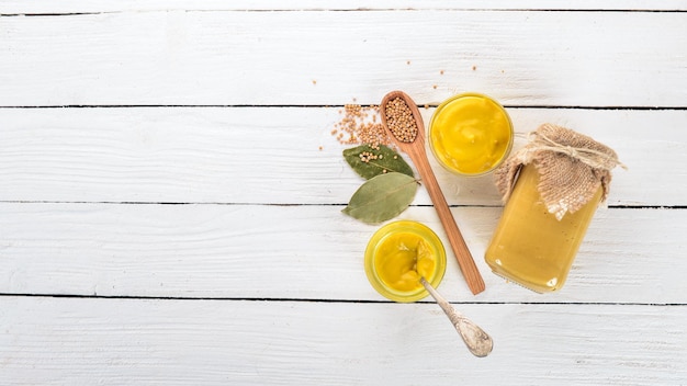 Mustard Sauce Spices On a white wooden background Top view Copy space for your text