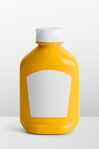 Photo mustard in yellow plastic bottle